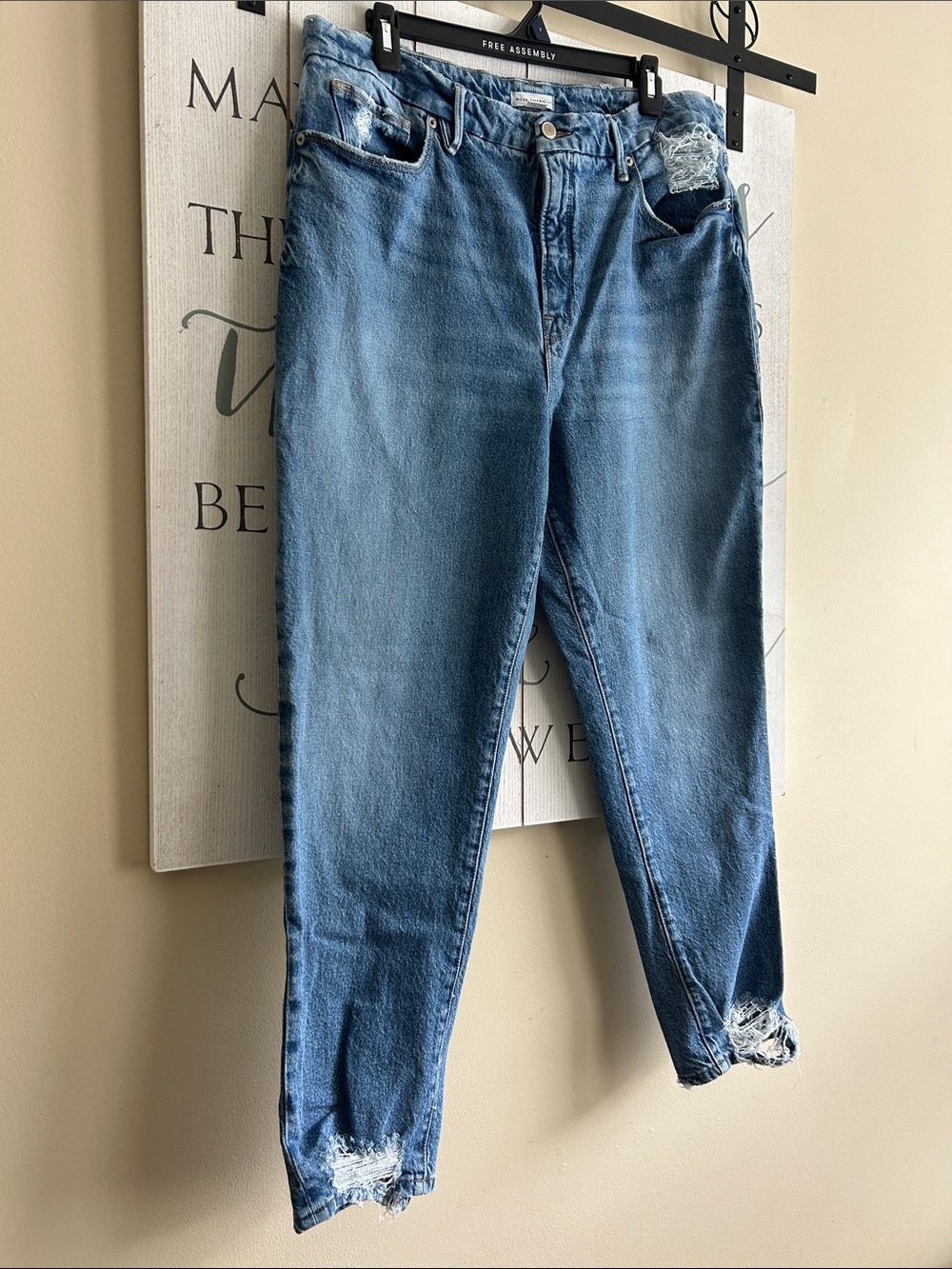 Good American medium-wash hi-rise jeans with distinct distressing, size 14/32